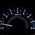 white and blue analog tachometer gauge
