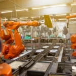 a factory filled with lots of orange machines