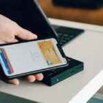 Hand holding a phone with a payment screen, illustrating Shopify checkout customization