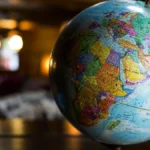 World globe in a warmly lit room, illustrating selling internationally with Shopify Markets