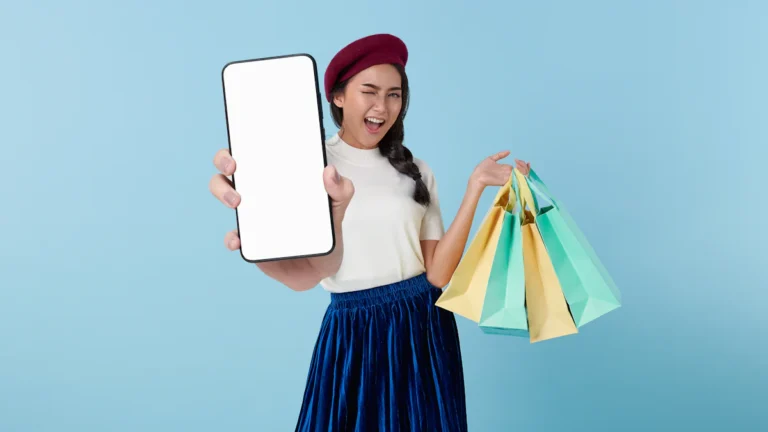 A woman holding a tablet computer and shopping bags