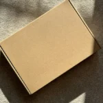 Cardboard shipping box in sunlight, illustrating Shopify shipping settings