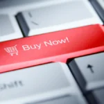 Red 'buy now!' button on a computer keyboard