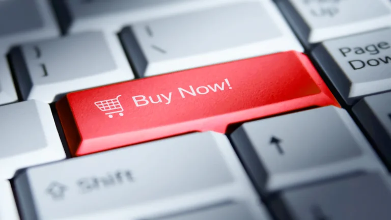 Red 'buy now!' button on a computer keyboard